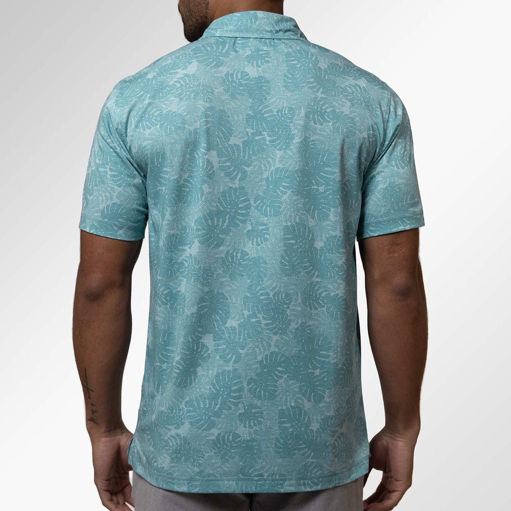 Man wearing a teal patterned shirt on a white background