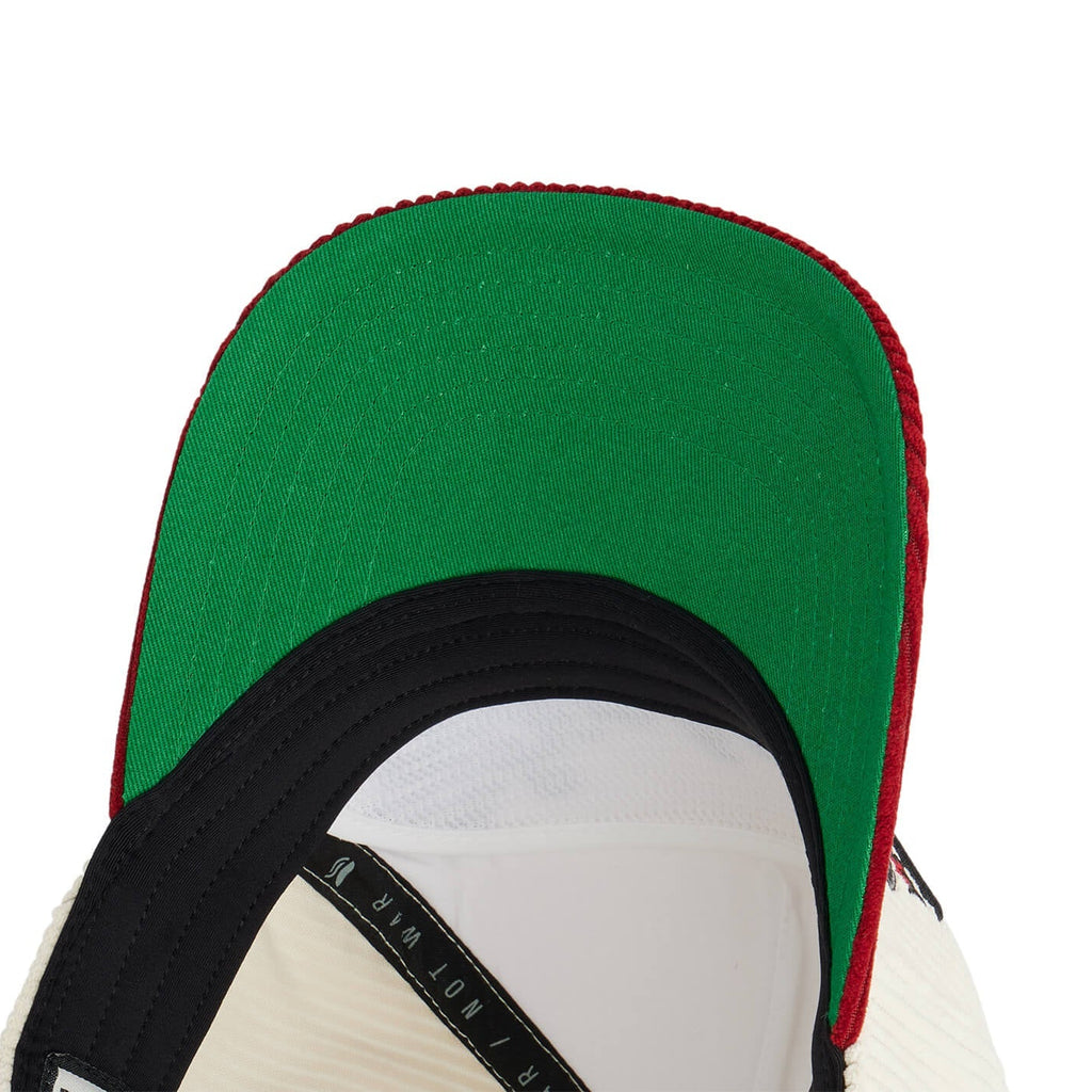 Close-up of a green, red, and black cap on a white background