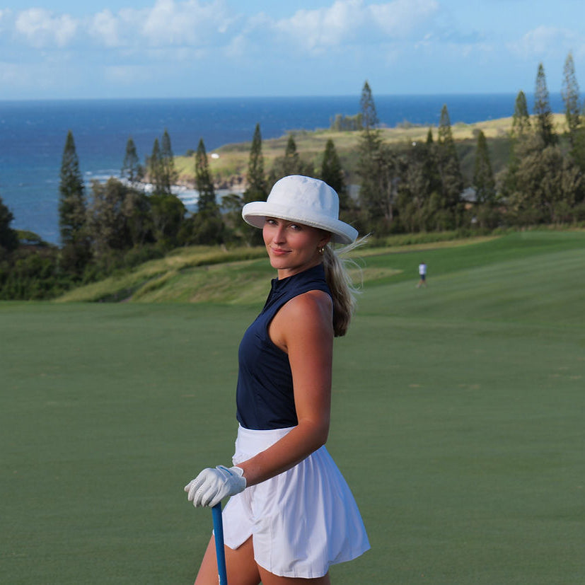 Woman on a golf course with ocean view