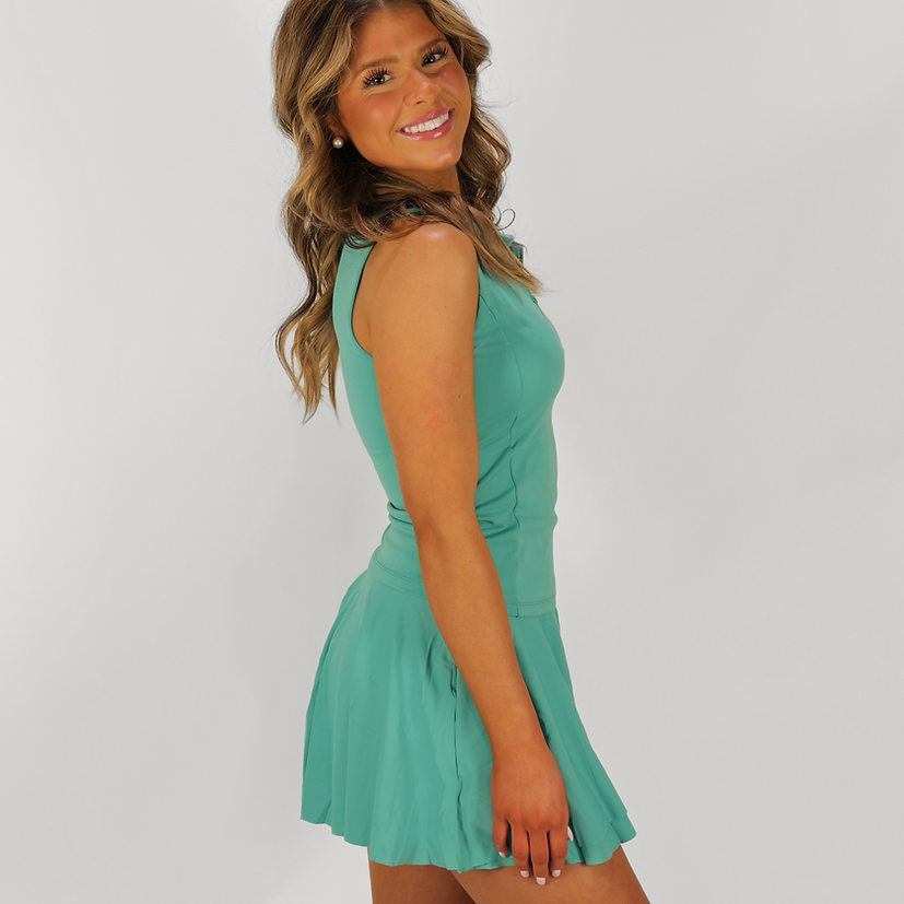 Woman wearing a green dress against a white background