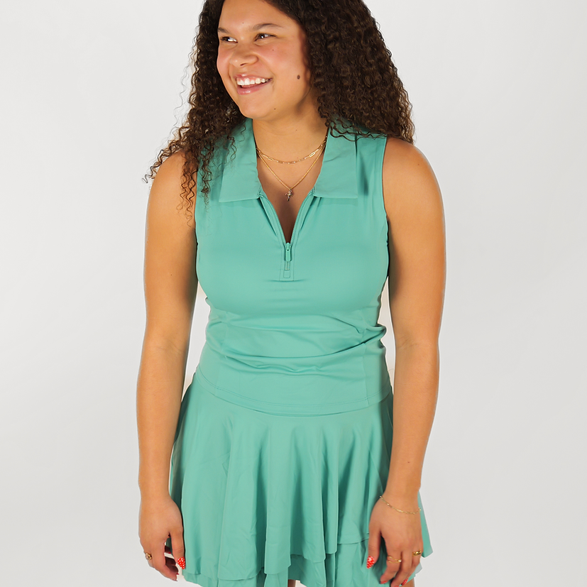 Woman wearing a green dress against a white background